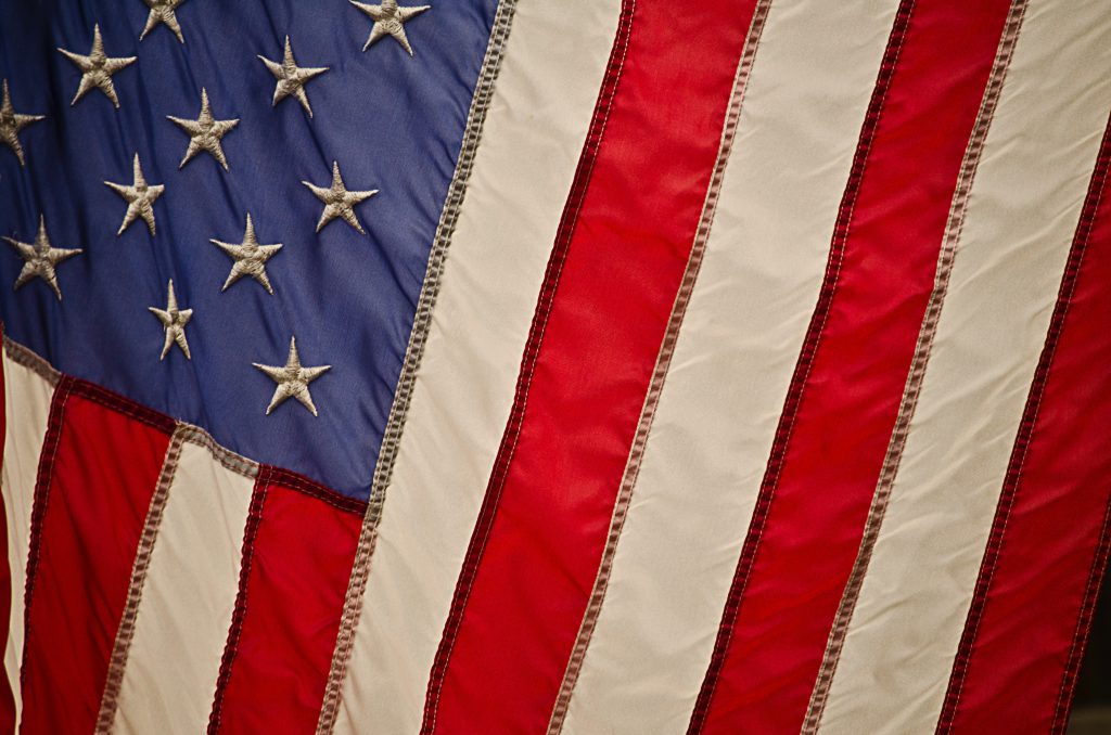 A close up of the American flag showing part of the stars and stripes on a diagonal angle. Our faith gives us freedom above and way beyond that which we enjoy in America today and both freedoms should be celebrated.