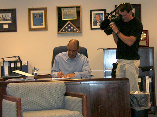 Camera man filming Coach Dungy in his office