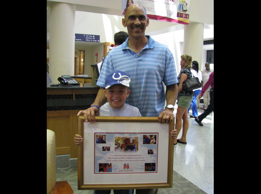 Tony Dungy with his award from Basket of Hope and Riley Hospital for Children!
