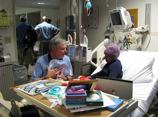 Winner talking with patients