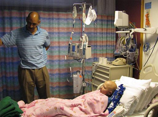 Tony Dungy talking with patient and autographing his pillow