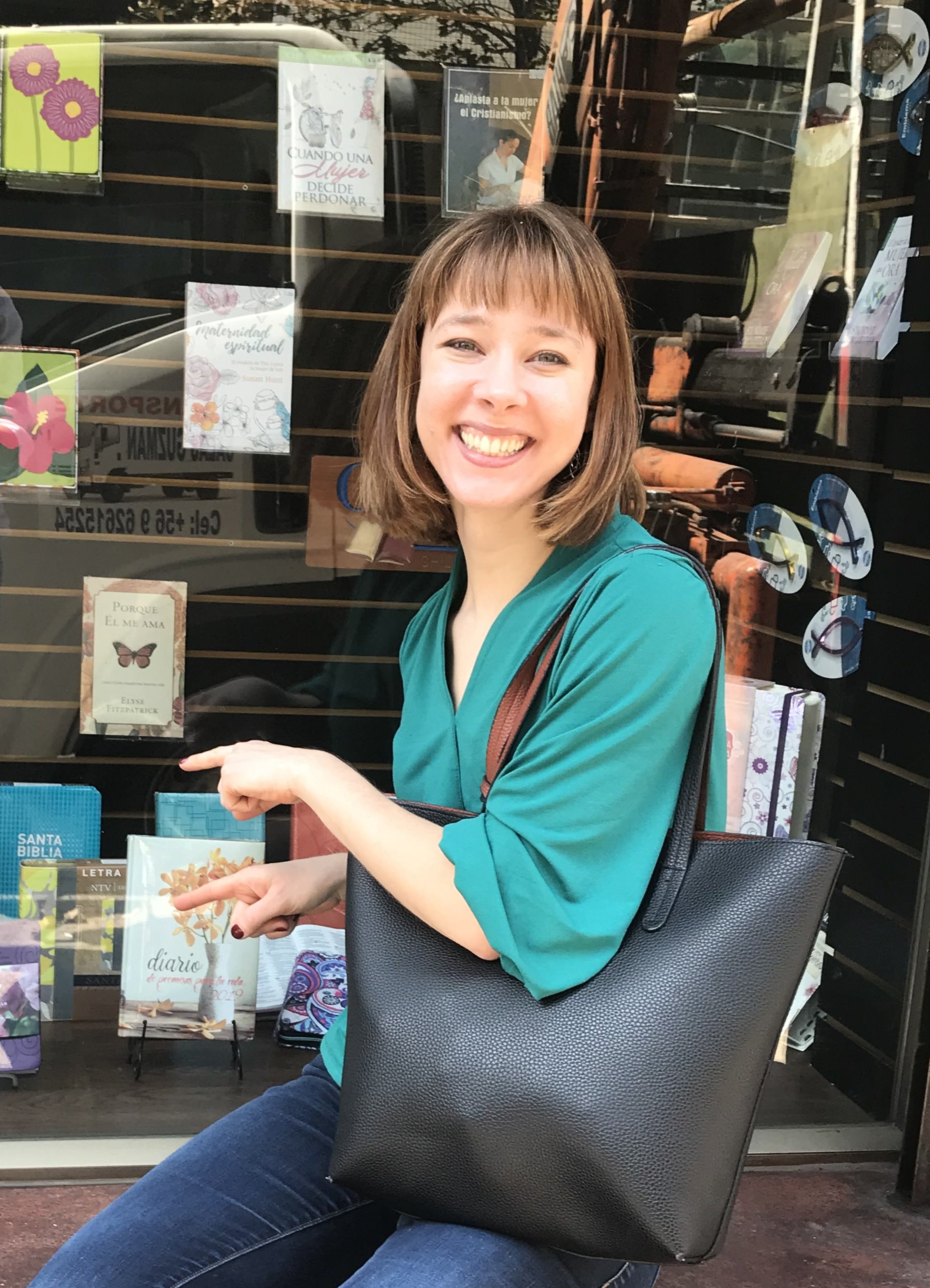 Christine sits outside a bookstore in Chile