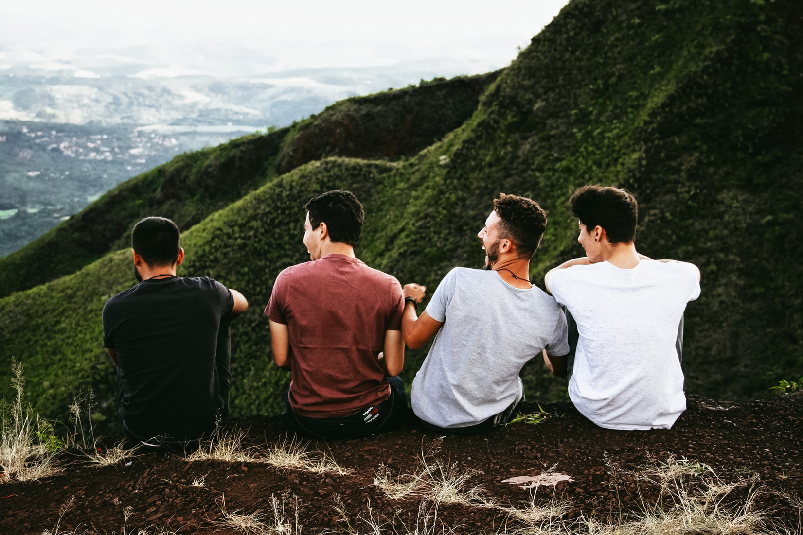 friends sitting outside on mountain