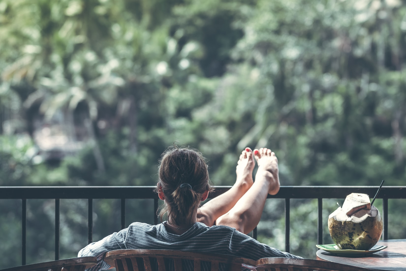 woman relaxing in chair near jungle