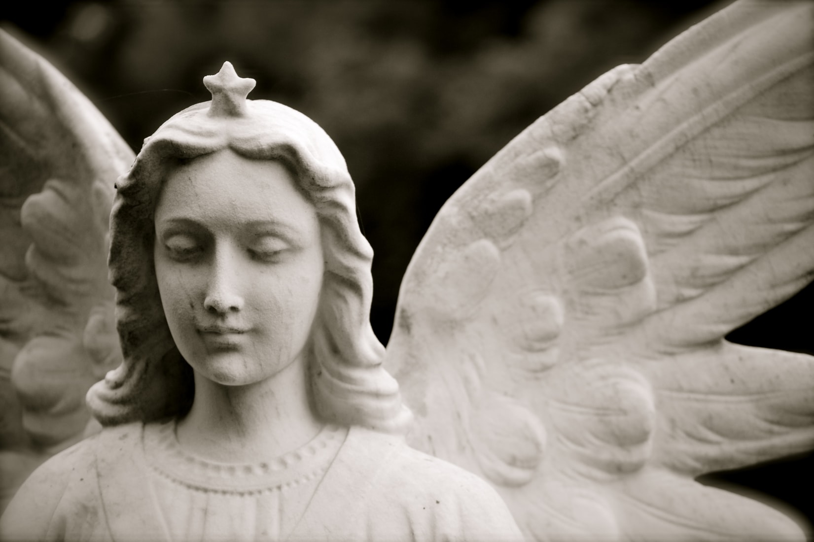 angel statue against dark background