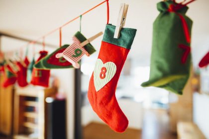 christmas stockings hanging on clothesline with clothes pins