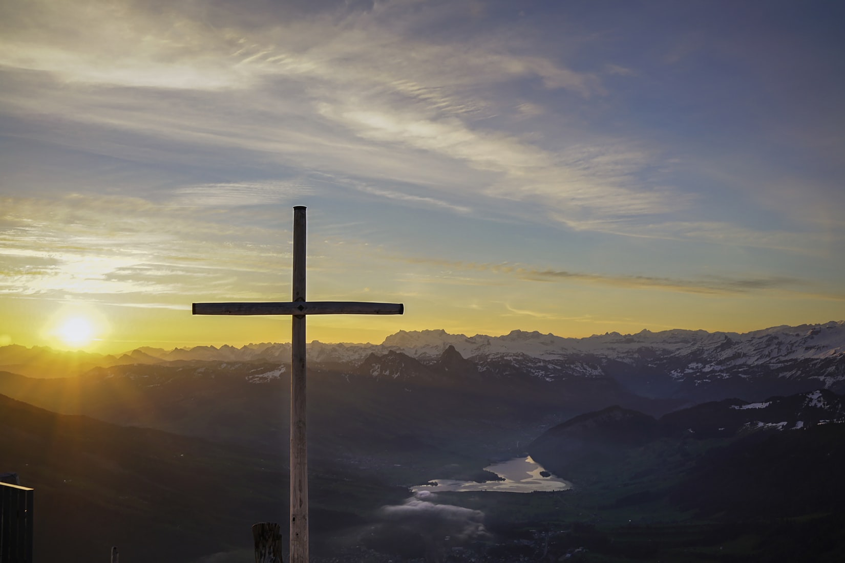 cross on mountain at sunrise