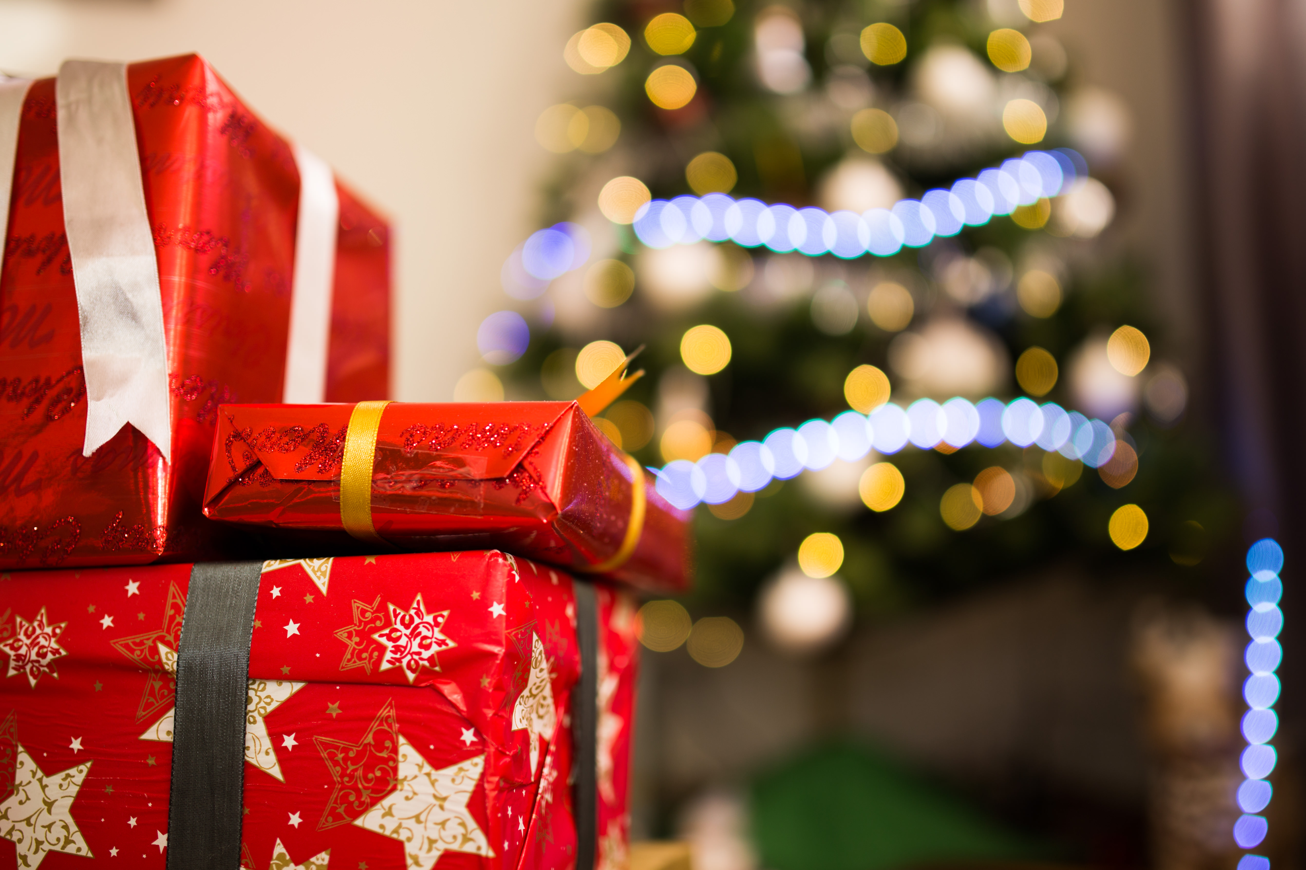 christmas gifts in front of christmas tree