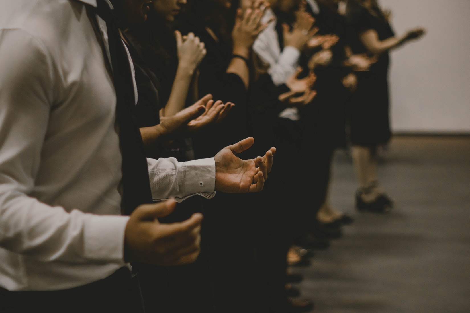 image of people's torsos while they pray together