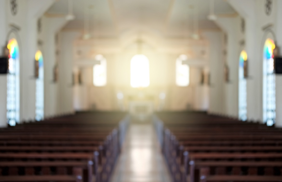 interior of empty church with light coming through front windows