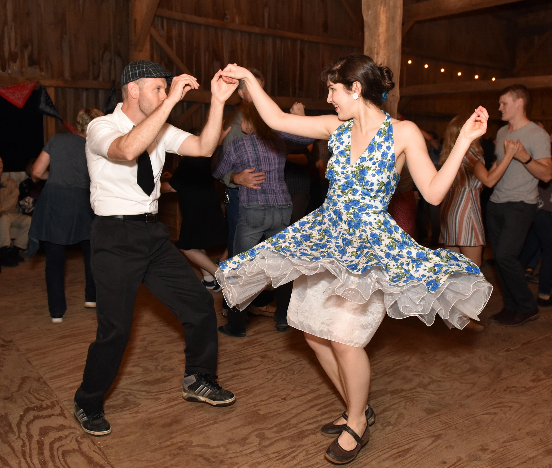 happy couple swing dancing wearing vintage clothing