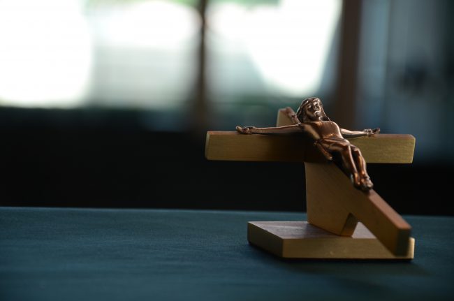 An image of Jesus on the Cross as a wooden statue, depicting Lent.