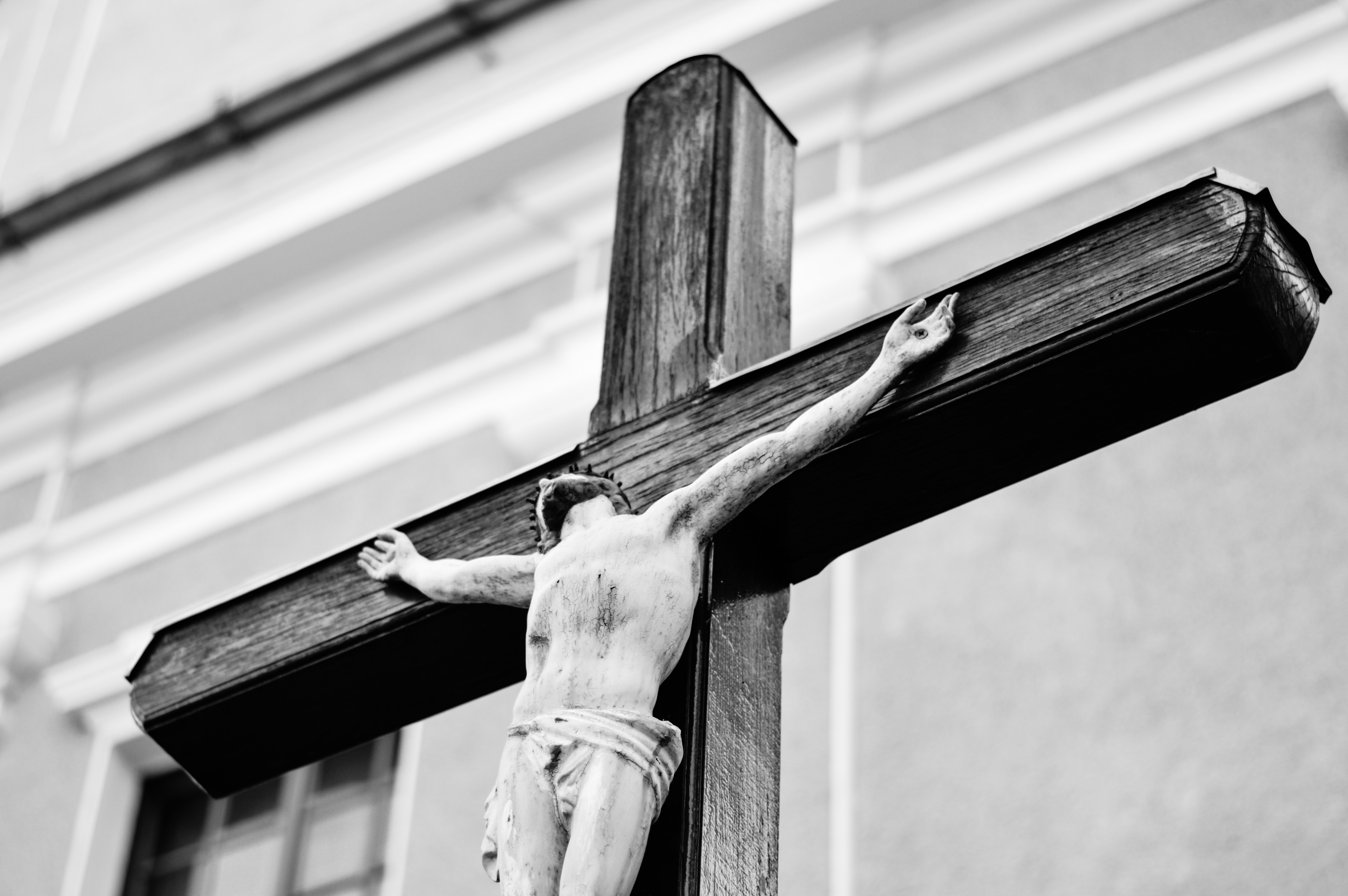 A black and white image of a statue of Christ on the cross.