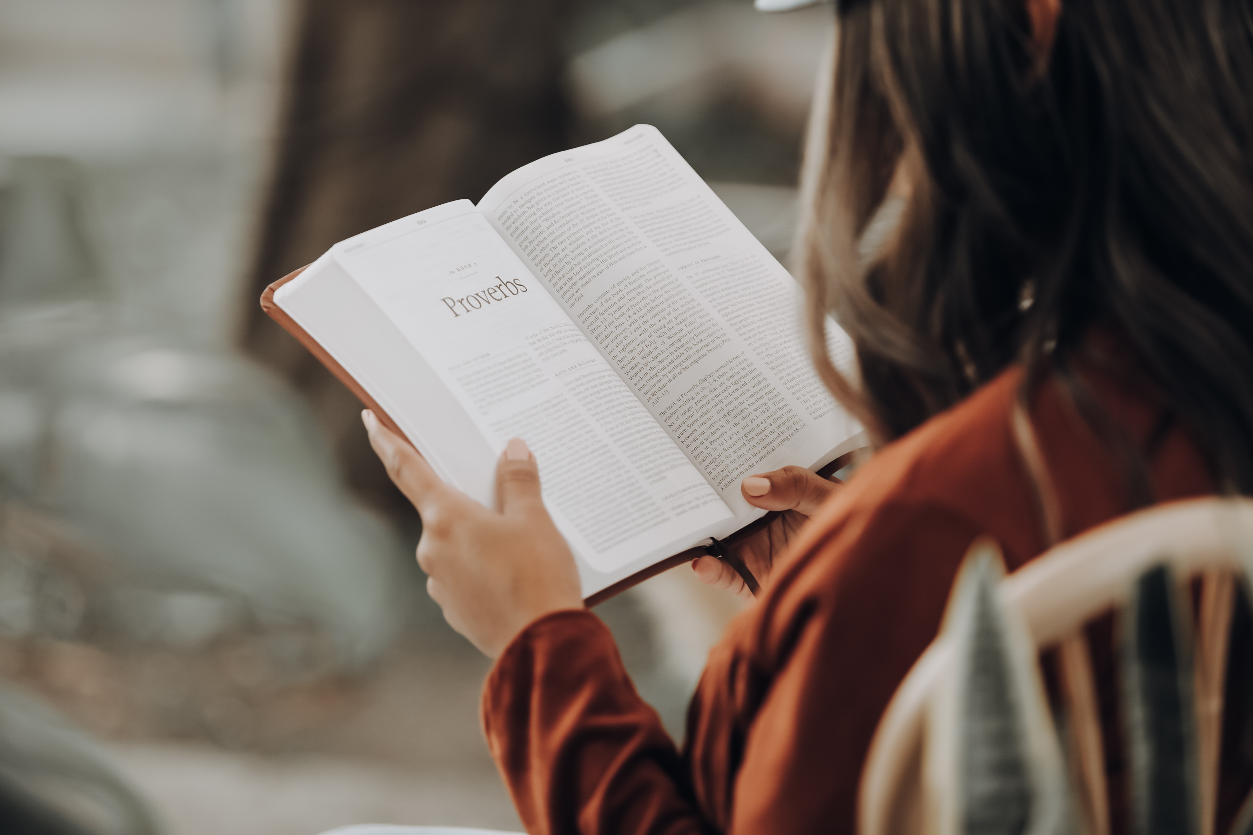 A woman reads The Proverbs in her Bible. In this article we explore why the Proverbs were given to us by God and why they are so important to our lives.