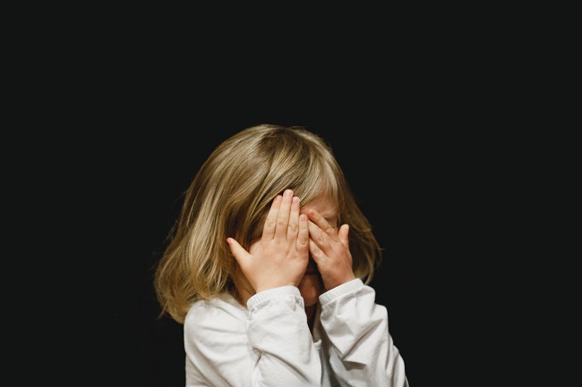 A young child hides their face behind their hands as if they have been naughty and wish to hide from God. It is too easy for humans to fall into sin because we defiantly disobey God everyday. God sees all this and chose to send His Son to help bridge the gap between us and the Lord.