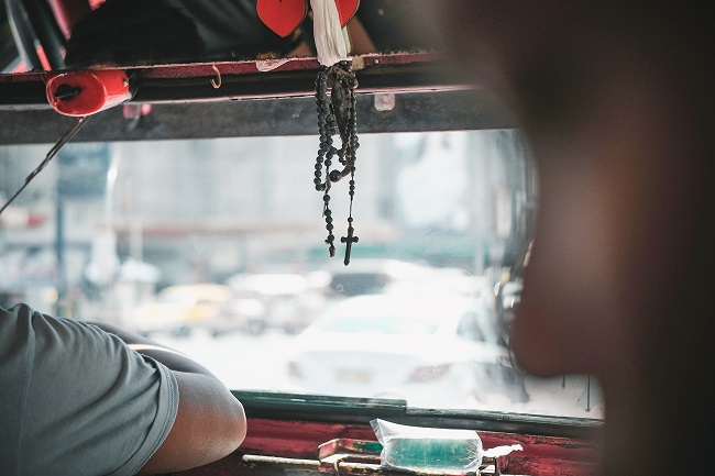 Sitting in the back of a Filipino cab. It can be very scary to let Jesus take the wheel in your life journey, but ultimately surrendering to Him is the best way to true freedom.