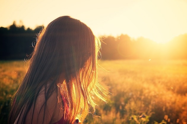 Girl in a field at sunset, her face is unseen. Talk about your testimony.