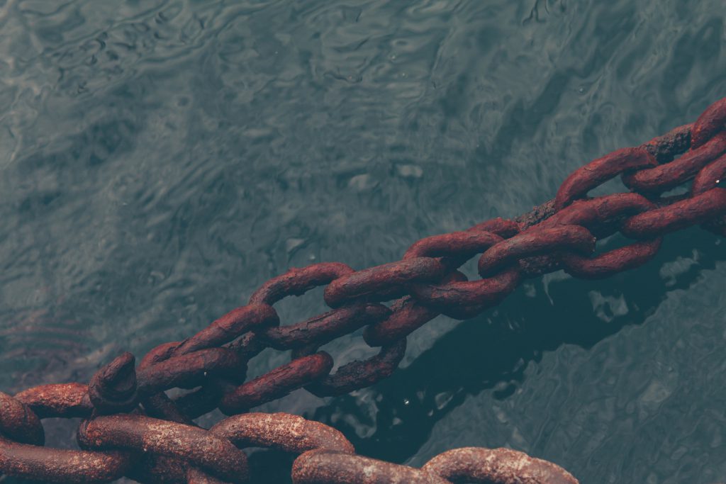 Is there anything God is willing to forgive? Rusty chains stand taught over dark water.