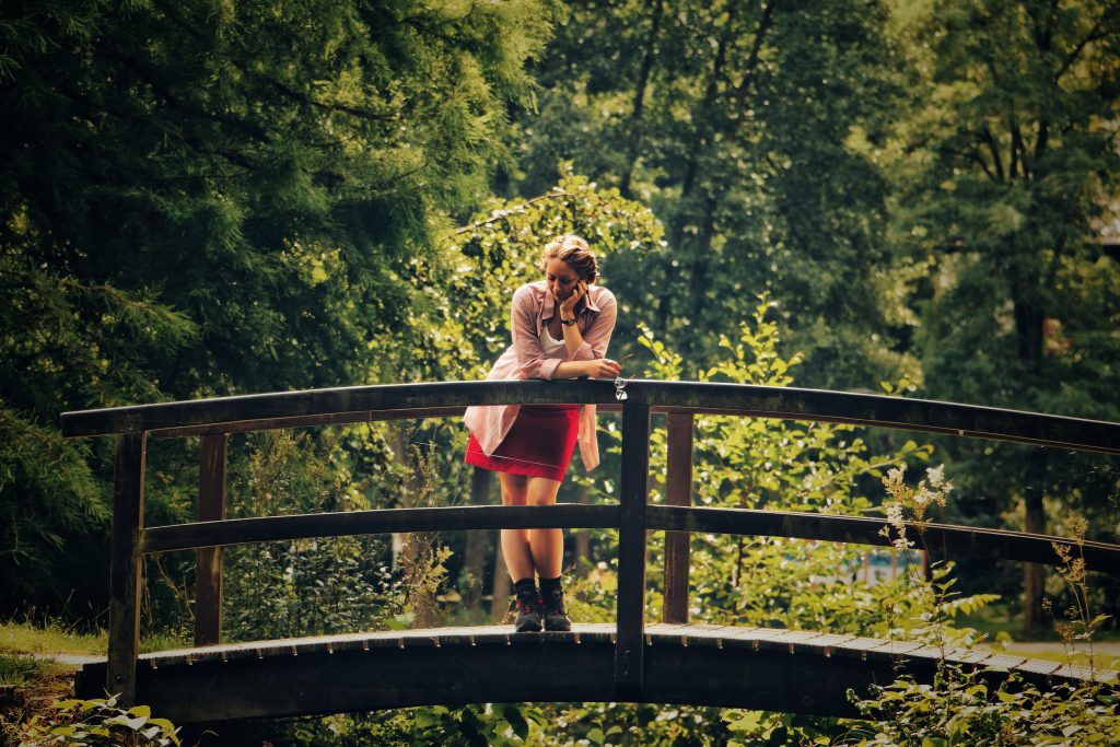 Girl on a bridge contemplating life. Share your testimony to potentially save a life!