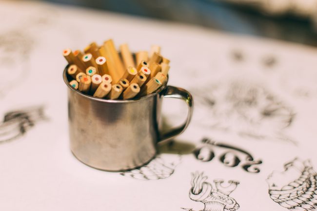 Image of colored pencils sitting in a tin mug on top of some artist drawings. Exploring the question of what is your life purpose and how do you use your gifts and skills for the Kingdom?