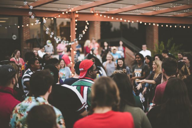 A large group of diverse people enjoy a party in an outside event space. Could you have the gift of hospitality? Do you enjoy organizing events? Answer questions to discover your life purpose.