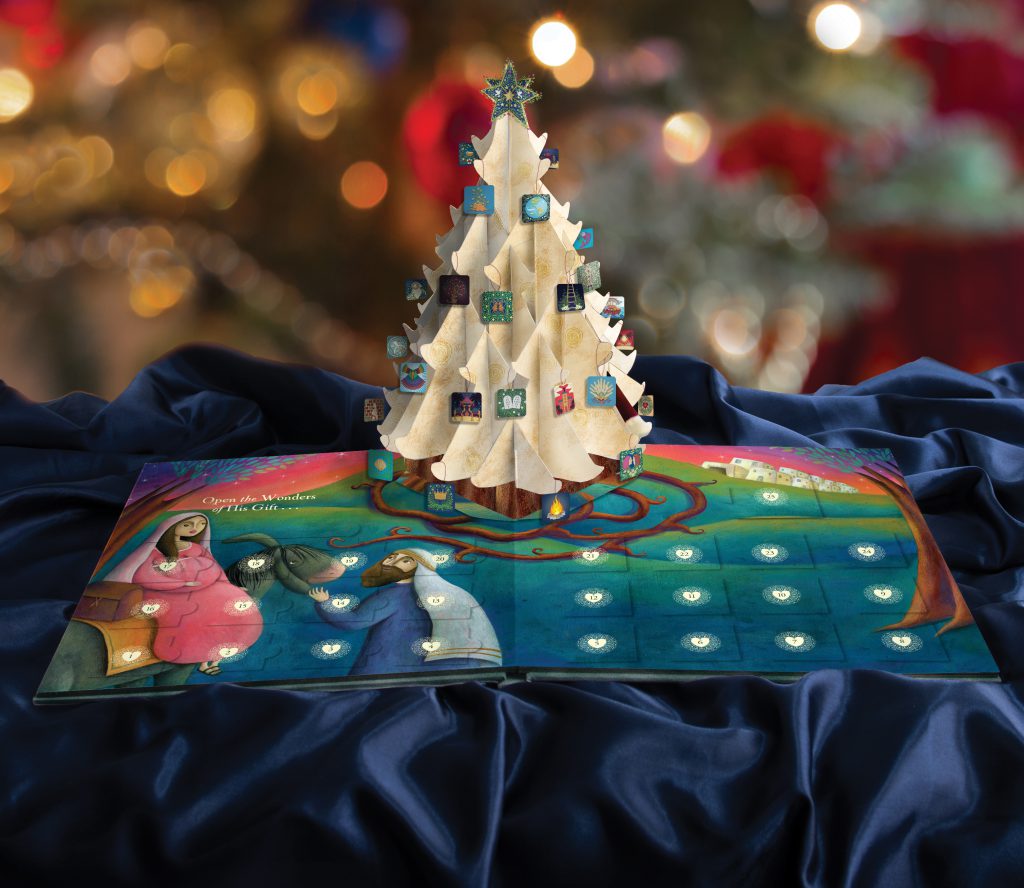 An image of The Wonder of The Greatest Gift book, with a pop-up Jesse Tree and Christmas ornaments. 