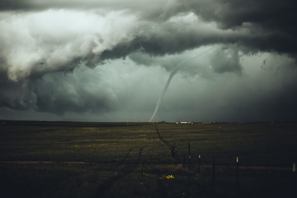 A twister hits the ground near property in the countryside. Referring to the question, why does God allow evil and suffering in the world?
